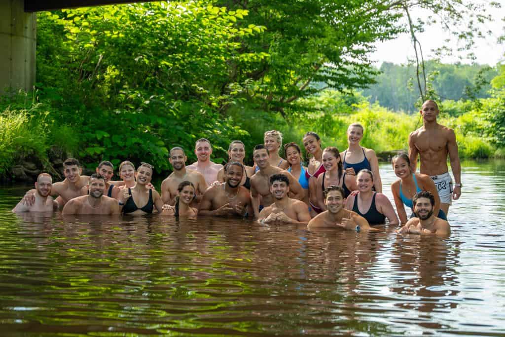 VTLZR retreat athletes gathered together in a lake