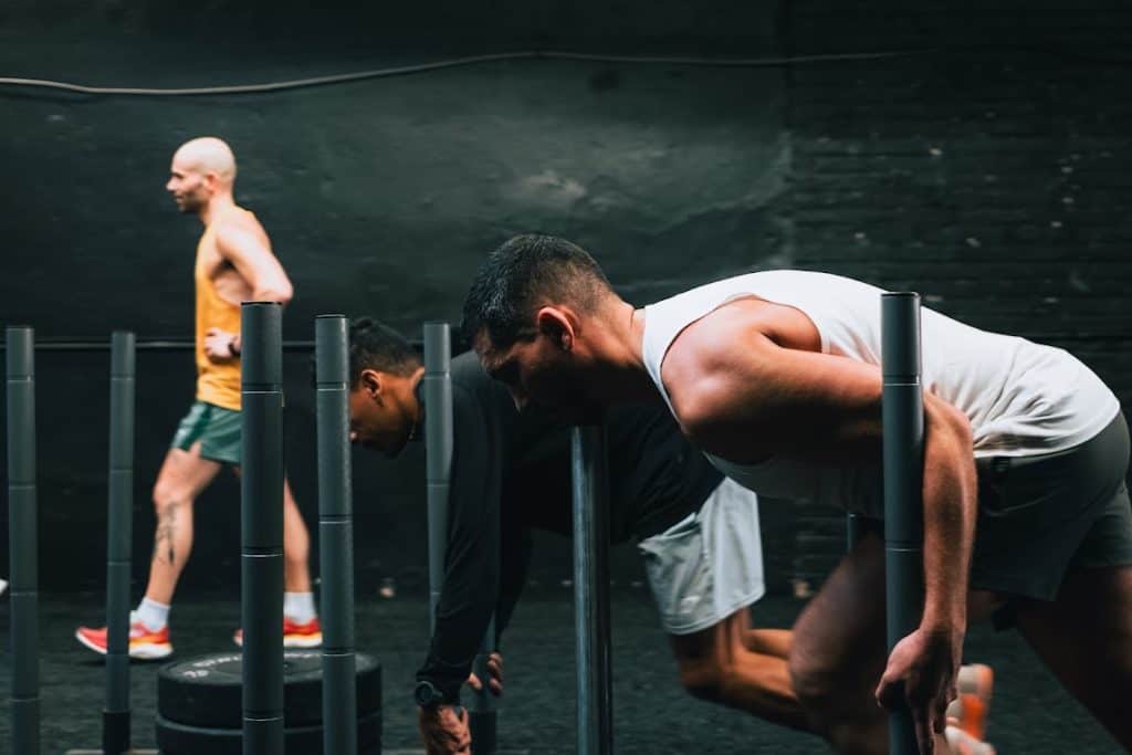 VTLZR athletes pushing sleds during a HYROX training session